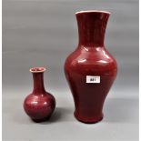 Chinese Sang du Boeuf baluster form vase, 14ins high together with a similar smaller vase, 7ins