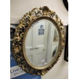 Late 19th / early 20th Century Florentine framed oval wall mirror, having shell and C-scroll