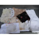 Quantity of crochet and table linen, two floral embroidered black silk panels etc
