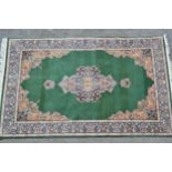 Indo Persian rug with central medallion and multiple borders on green ground, 88ins x 54ins Some