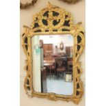 18th Century Irish carved and gilded wall mirror, the floral surmount above a rectangular plate with