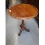 Victorian mahogany circular pedestal table with a turned column support and tripod base