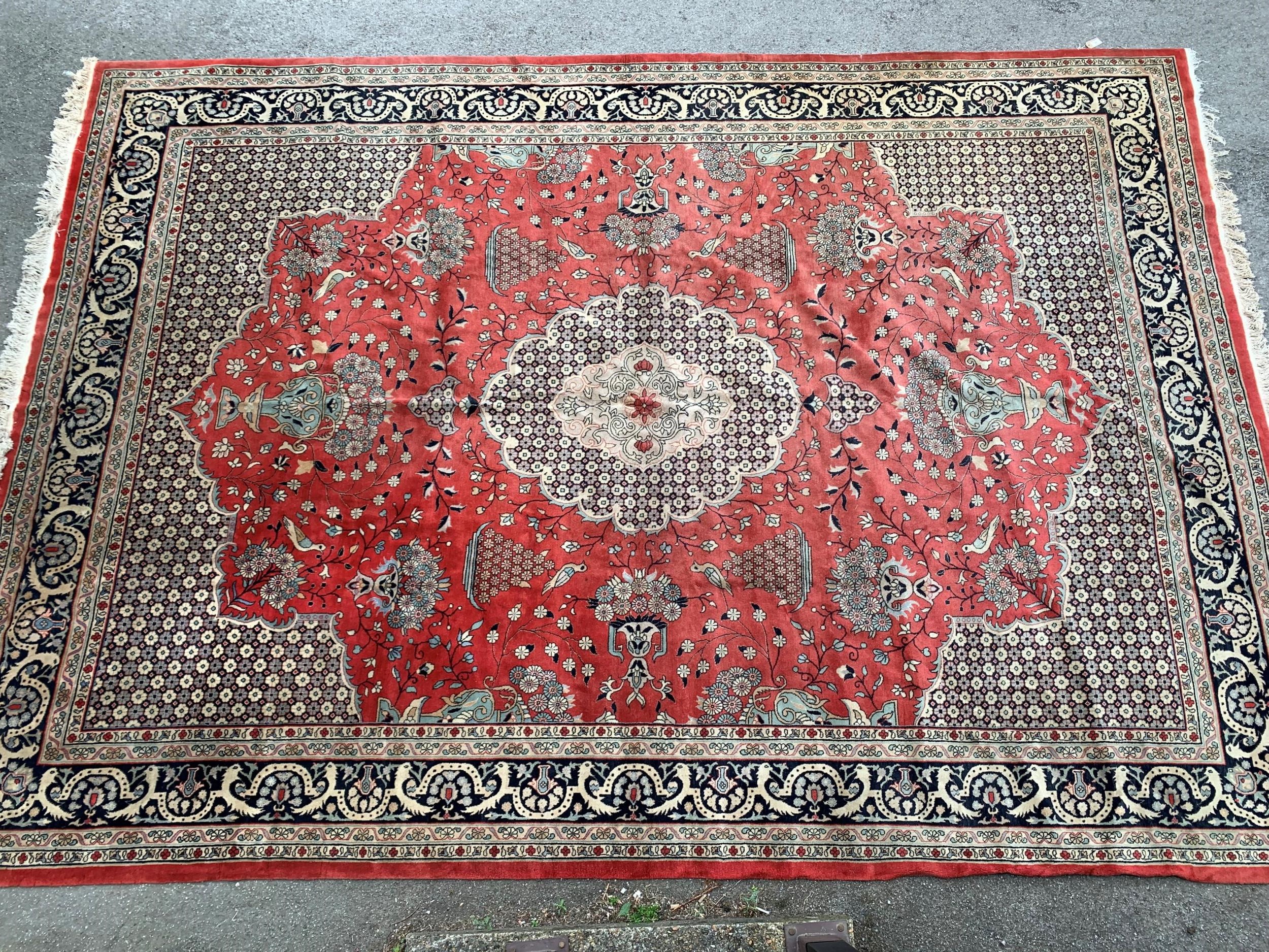 Large Indo Persian carpet with a medallion and vase design on a salmon ground with corner designs