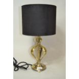 Art Nouveau brass table lamp on a circular base with low feet