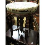 19th Century walnut stool, the circular padded seat above a centre column and four turned supports