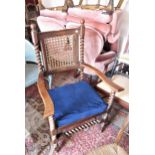 Early 20th Century walnut open armchair in Carolean style with a cane back and seat on barley