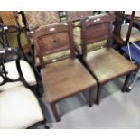 Pair of Victorian Gothic revival hall chairs with panelled backs, plank seats and square cut