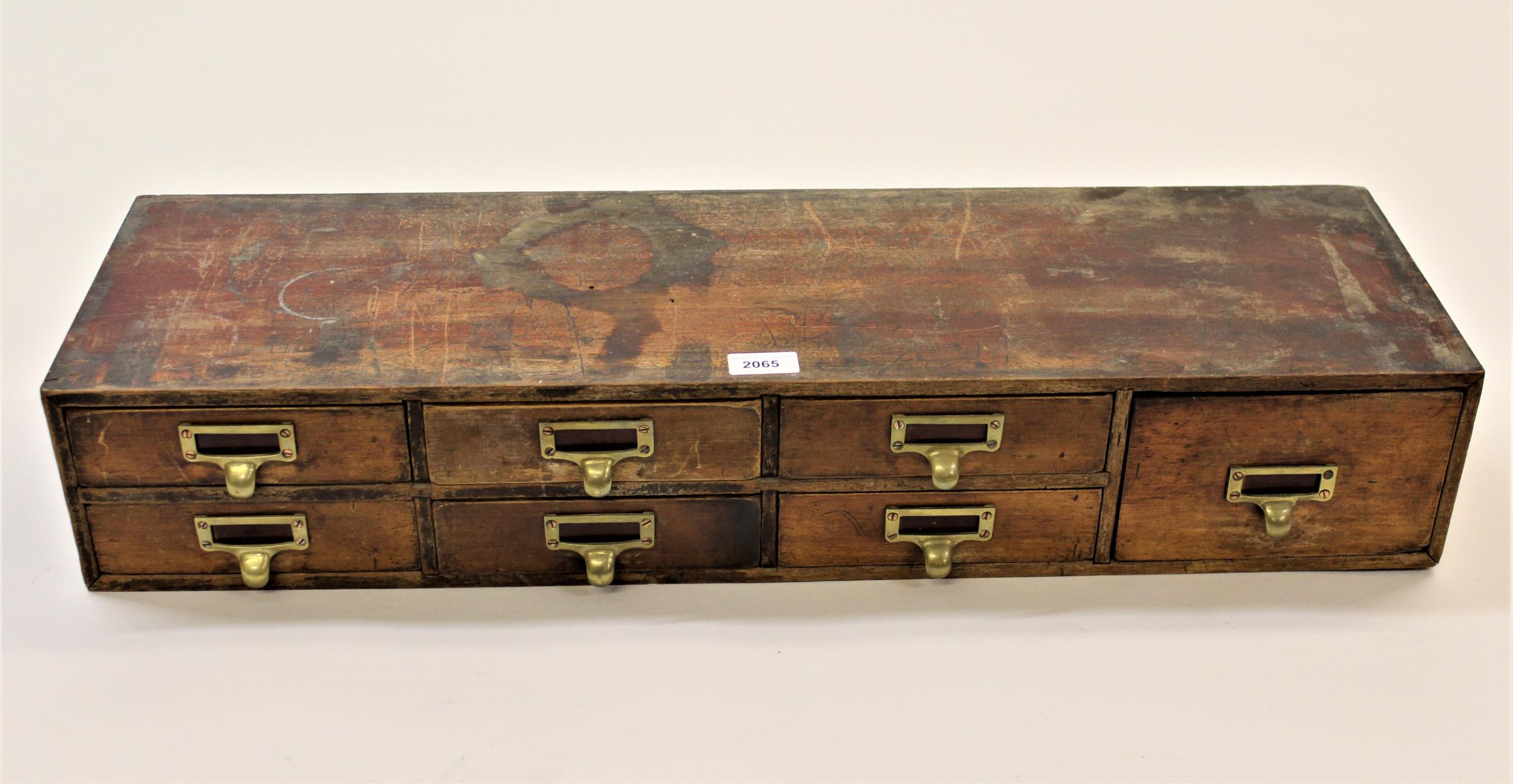 Small 19th Century mahogany bank of seven drawers with brass handles, 31ins x 5.5ins