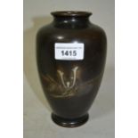 Japanese brown patinated bronze baluster form vase, silver inlaid with decoration, signed with