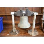 Mid 20th Century bell, 9.5ins high approximately, with bracket and associated stands