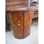 18th Century walnut crossbanded and herringbone inlaid bow front hanging corner cabinet, the moulded