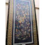 Chinese sleevework panel on blue silk, figures in a festival scene with dragon, 22ins x 9.5ins, in