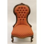 Victorian carved walnut button upholstered low seat nursing chair on cabriole front supports