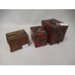 Two Japanese red lacquer jewel caskets with brass mounts and carrying handles and another Japanese