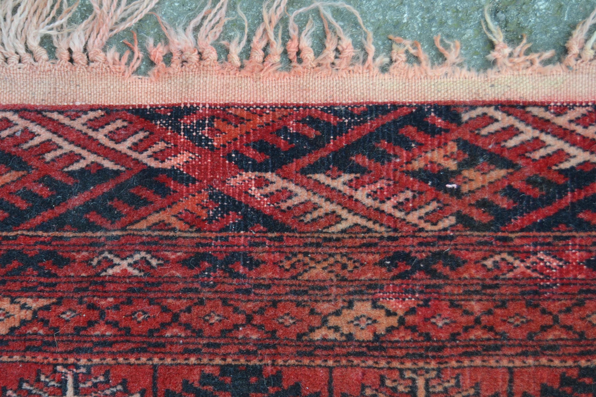 Small Turkoman rug with three rows of twelve gols on a wine ground with multiple borders, 5ft - Image 3 of 3