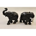 Pair of large carved ebony figures of elephants (minus one bone tusk and at fault), the tallest