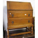 Mid 20th Century oak bureau, the full front and closing fitted interior above two drawers, on turned