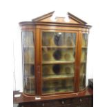 Edwardian mahogany and marquetry inlaid wall cabinet, the broken arch pediment above a glazed door