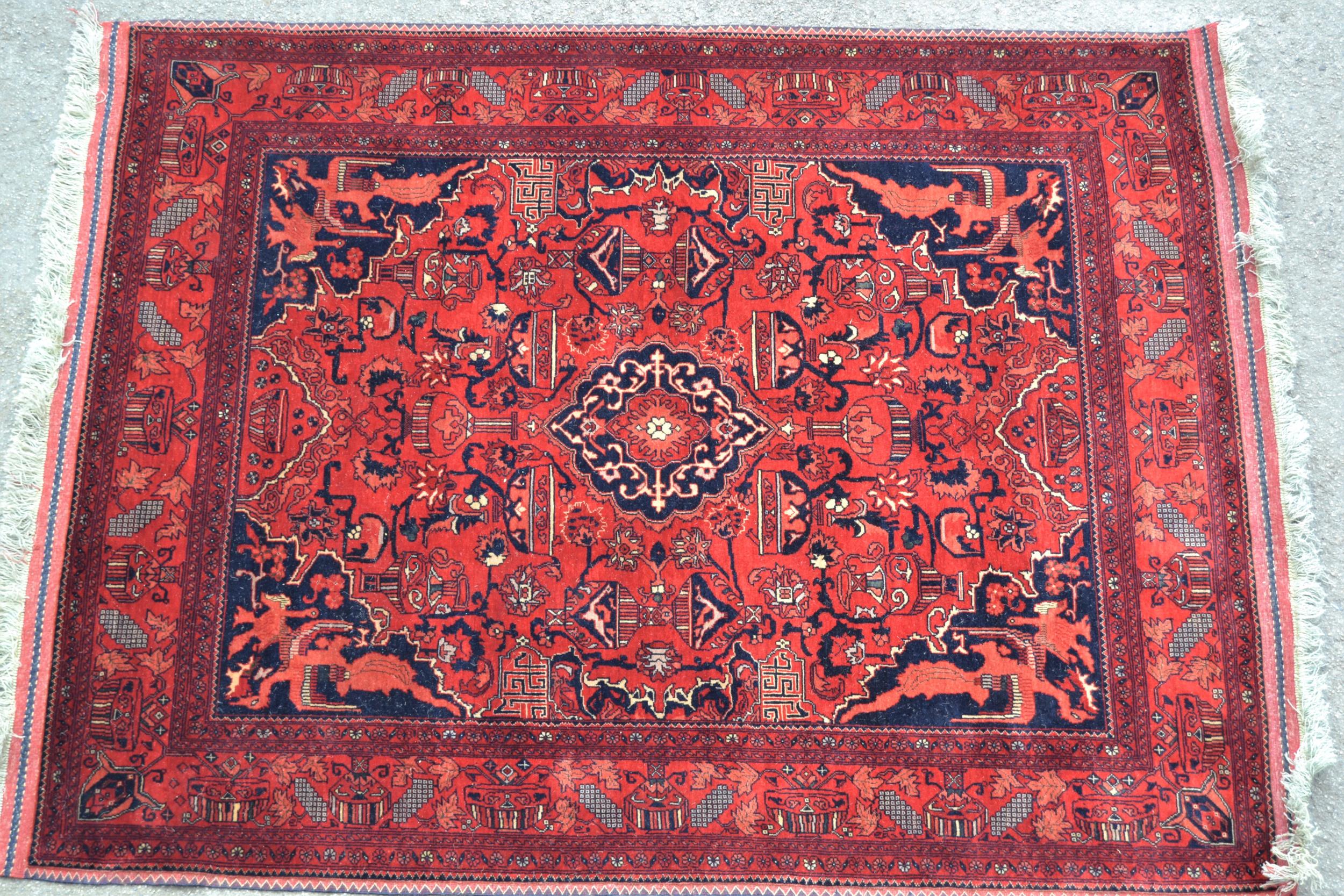 Afghan rug with a medallion and all-over stylised design, corner designs and borders, 6ft 4ins x 5ft