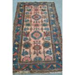 Small Kurdish rug with an all-over stylised design on a salmon ground with borders, 6ft x 3ft 8ins