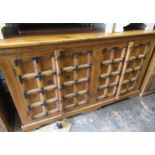 Modern oriental hardwood and iron mounted side cabinet with two pairs of panelled doors on bracket