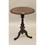 Victorian figured walnut circular pedestal table, the carved rim above a baluster column and