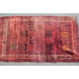 Afghan rug with an all-over panel design in shades of red, orange and black, 7ft 6ins x 4ft 10ins