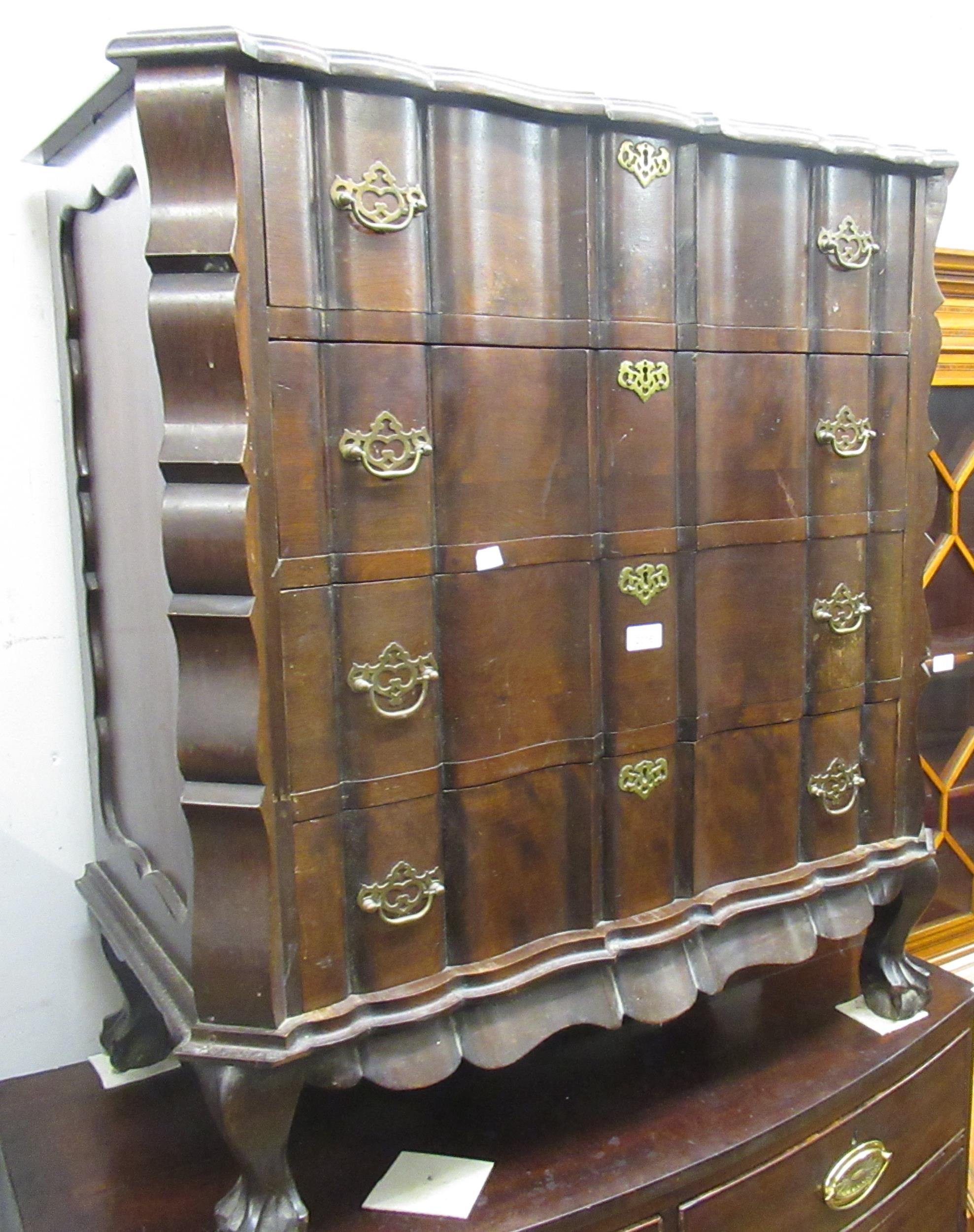 Early 20th Century hardwood straight front chest with four shaped front drawers having brass