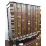 Early 20th Century hardwood straight front chest with four shaped front drawers having brass