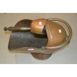 Copper helmet shaped coal scuttle with shovel