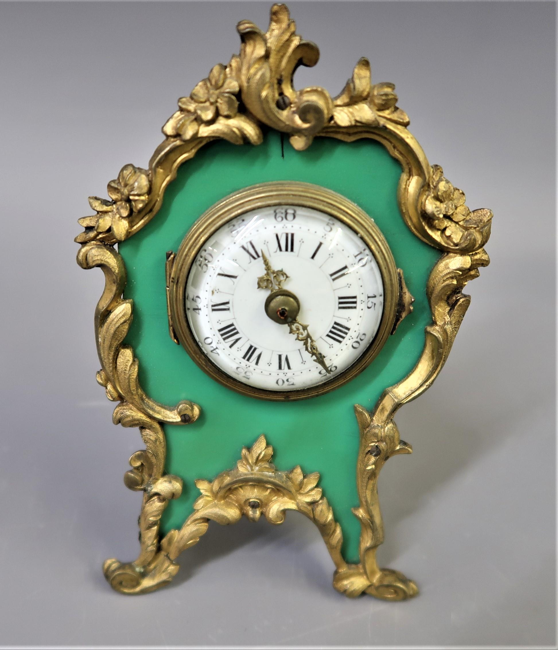 Small French gilt metal mantel clock, having circular enamel dial with Arabic and Roman numerals,