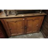 Early 20th Century oak side cabinet with two moulded panel doors on low supports, 7ins wide x