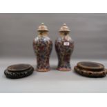 Pair of late 19th / early 20th Century Chinese porcelain baluster form vases with covers,