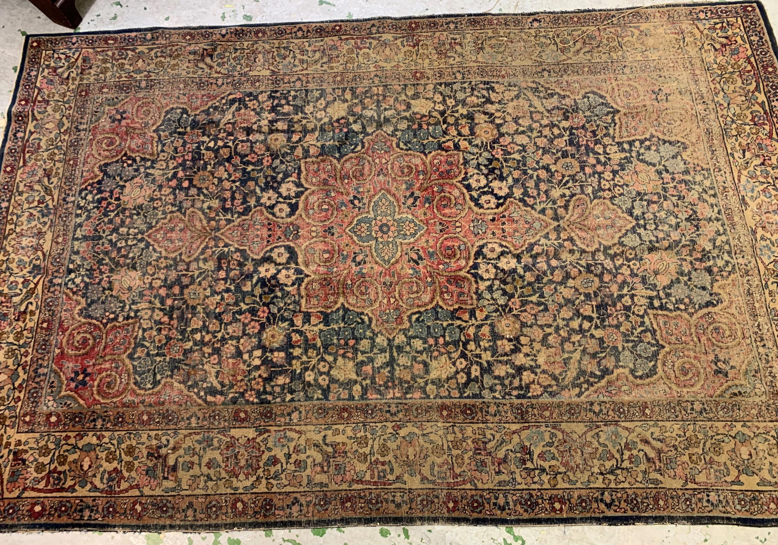 Tabriz carpet with a lobed medallion and all-over floral design on a midnight blue ground with