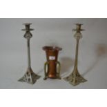 Arts and Crafts copper and brass three handled vase and a pair of Arts and Crafts style candlesticks