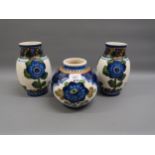 Group of three Copenhagen pottery floral decorated baluster form vases