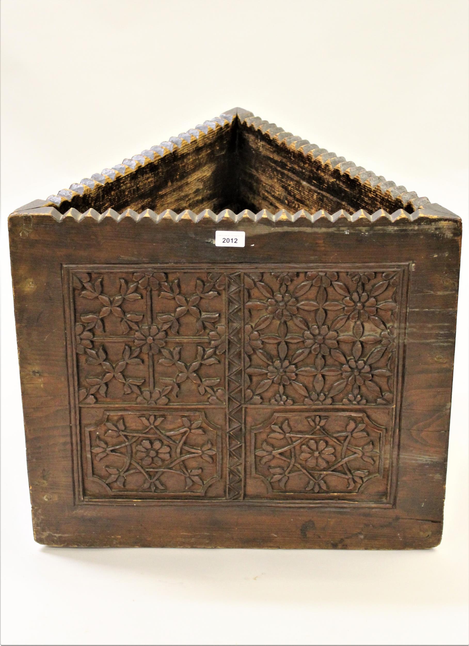 19th Century carved wooden triangular stickstand with all-over floral carved decoration, 21ins high
