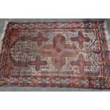 Belouch rug with centre medallion and multiple borders on a beige ground, 57ins x 37ins