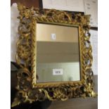 Small late 19th / early 20th Century Florentine carved giltwood cushion framed mirror, 14.5ins x