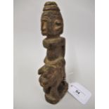 Small African (Mali) carving of a figure riding an animal, 7.25ins high