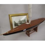 Wooden model of a single-masted sailing yacht, together with a reproduction black and white