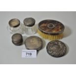 Silver compact, three silver top jars, two silver backed brushes and a silver cover