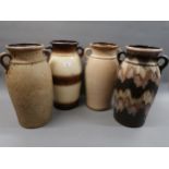 Group of four large German stoneware two handled baluster form vases, 17ins high