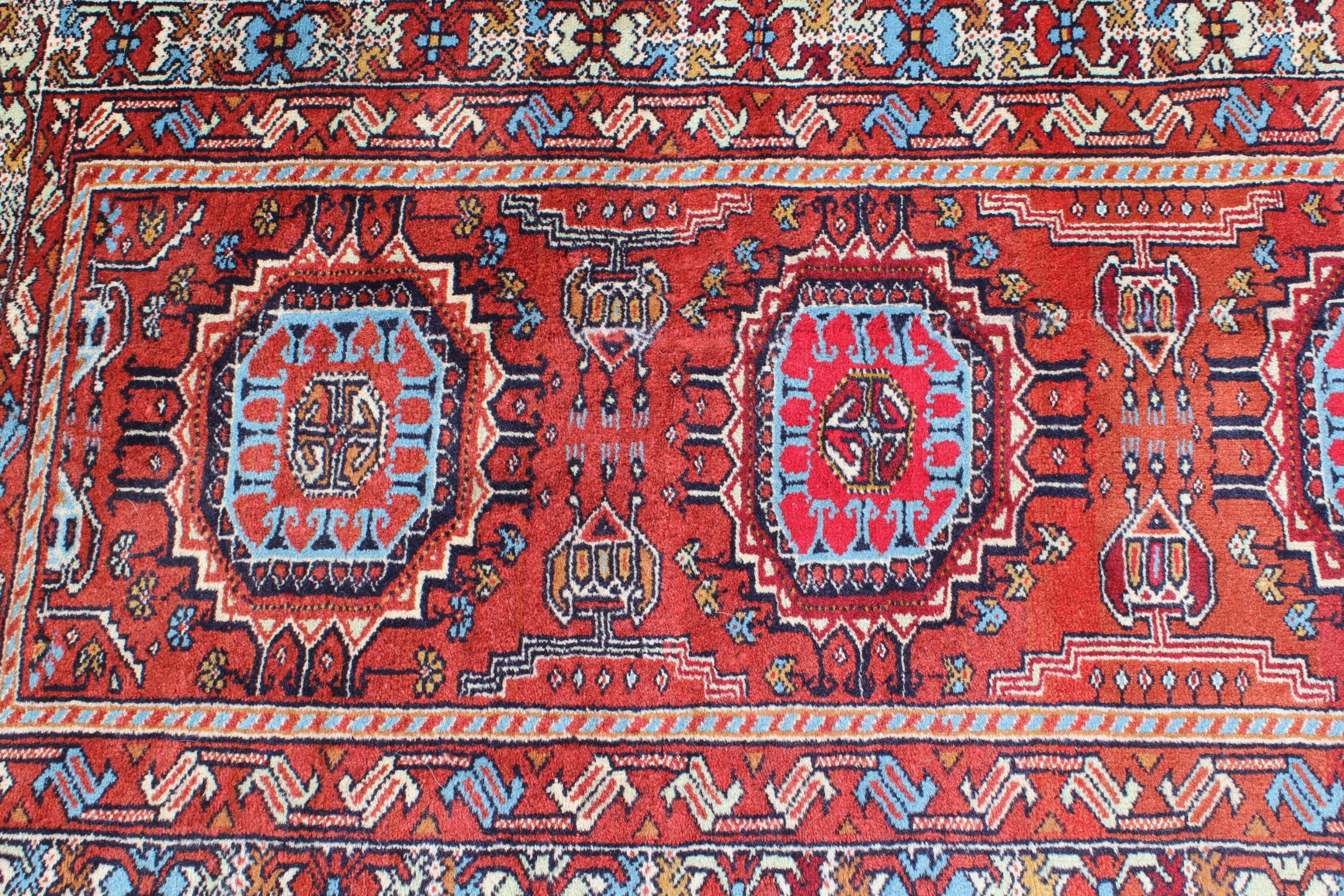 Indo Persian runner of Afghan design with a repeating hooked medallion pattern, on a rose ground - Image 2 of 6
