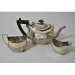 Sheffield silver three piece bachelor's teaset of oval form with half gadroon decoration, makers