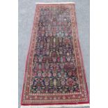 Modern central Persian rug with an all-over stylised flower head design on a midnight blue ground