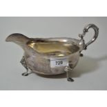 George III London silver large helmet shaped sauce boat with C-scroll handle and hoof supports (