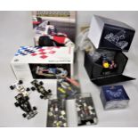Small collection of Red Bull Grand Prix car models, a miniature steering wheel and nose cone,