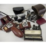 Leather cased early calculator, pair of opera glasses in partial leather case, three various cameras