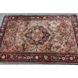 Sarouk rug with a medallion and floral design on an ivory ground with borders, 5ft x 3ft 4ins